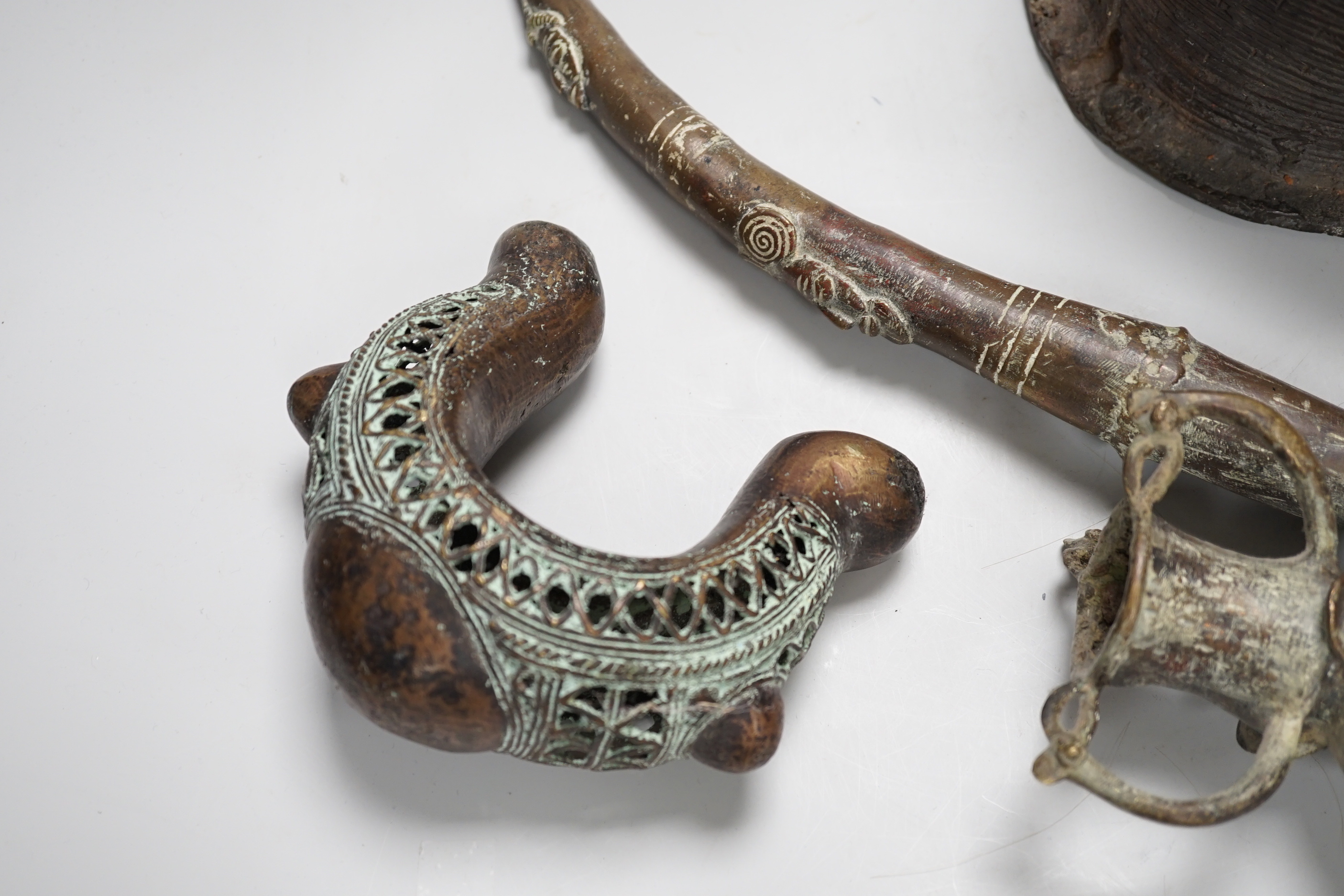 West African bronzes: Benin, a male and a female head, bangle anklet, a ceremonial pipe, ornamental ladle (5)